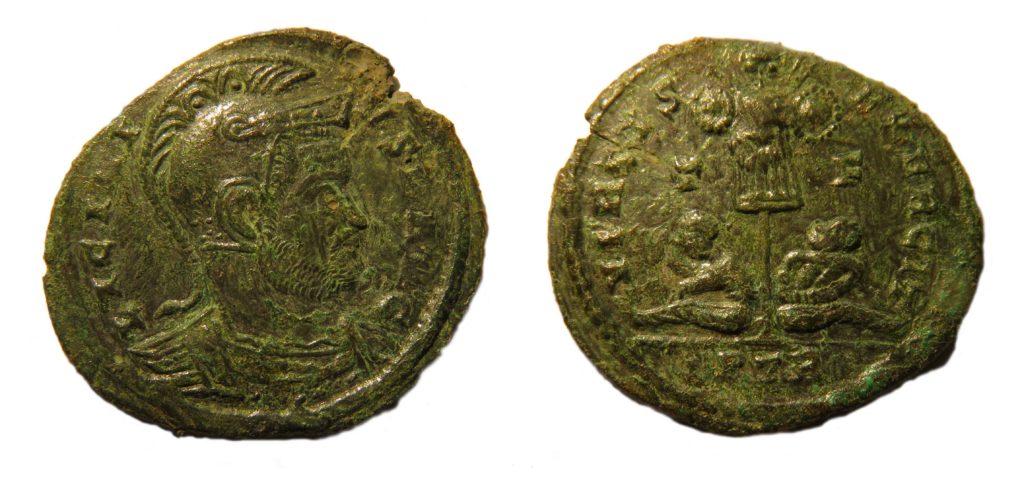 A nummus of Licinius II, VIRTVS EXERCITVS, reverse type depicting two prisoners seated under standard. Copyright: Trustees of the British Museum. License: Attribution License.