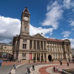 A photograph of Birmingham Museum, taken from Chamberlain Square, showing the clock tower and the portico entrance